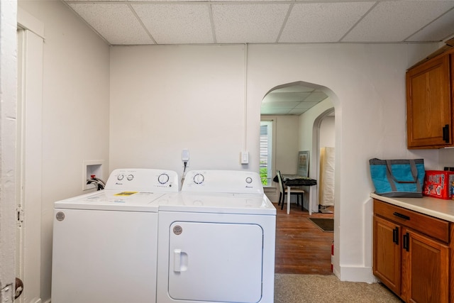 121 Cherry Ave, Ames, IA 50010 - washroom featuring washer and clothes dryer, cabinet space, arched walkways, and light wood-style floors