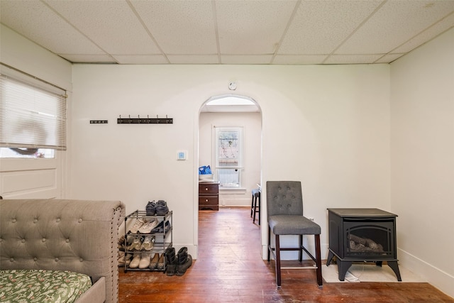 121 Cherry Ave, Ames, IA 50010 - sitting room with a wood stove, arched walkways, wood finished floors, and a drop ceiling