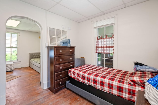 121 Cherry Ave, Ames, IA 50010 - bedroom with a paneled ceiling, wood finished floors, and arched walkways