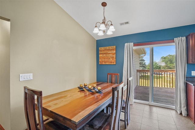 16215 Monroe Ct, Urbandale, IA 50323 - dining space featuring a chandelier, vaulted ceiling, and light tile patterned floors