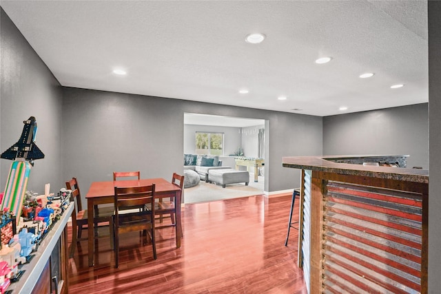 16215 Monroe Ct, Urbandale, IA 50323 - dining space with wood finished floors, recessed lighting, a dry bar, and a textured ceiling