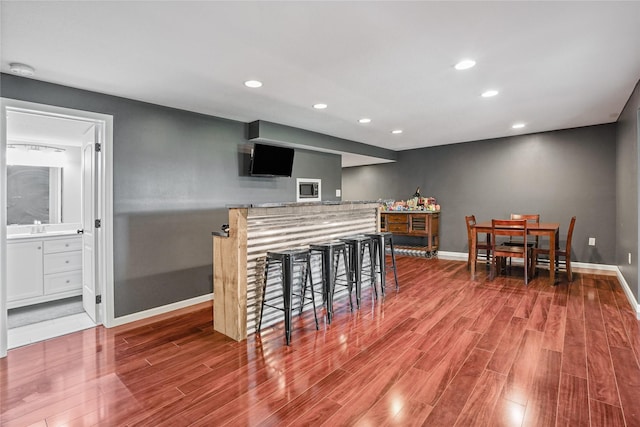 16215 Monroe Ct, Urbandale, IA 50323 - bar featuring wood finished floors and recessed lighting