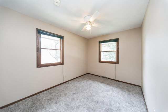 2424 Guenever Ct, Altoona, IA 50009 - spare room with light colored carpet, a ceiling fan, and a smoke detector