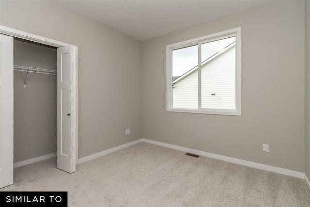 1435 Locust St, Waukee, IA 50263 - unfurnished bedroom featuring carpet floors and a closet