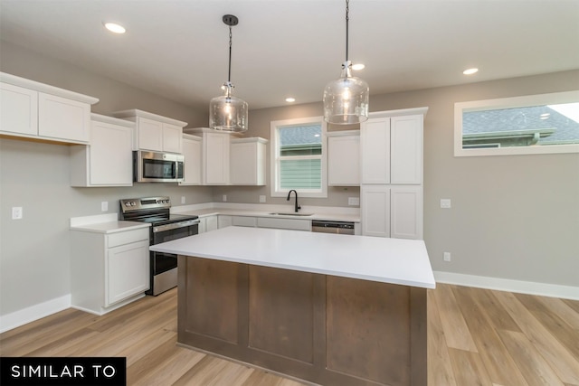 1435 Locust St, Waukee, IA 50263 - kitchen with appliances with stainless steel finishes, light wood-style floors, white cabinets, light countertops, and recessed lighting