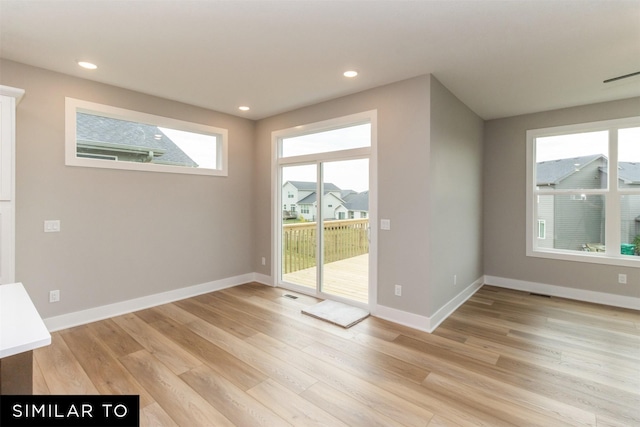 1435 Locust St, Waukee, IA 50263 - unfurnished room featuring light wood finished floors, plenty of natural light, and recessed lighting