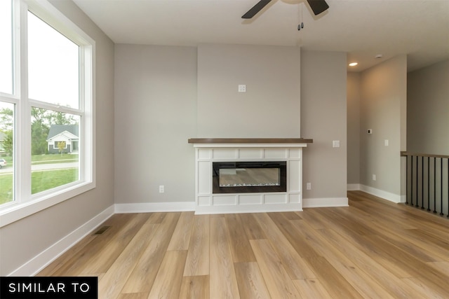 1435 Locust St, Waukee, IA 50263 - unfurnished living room with a ceiling fan, wood finished floors, a glass covered fireplace, and recessed lighting