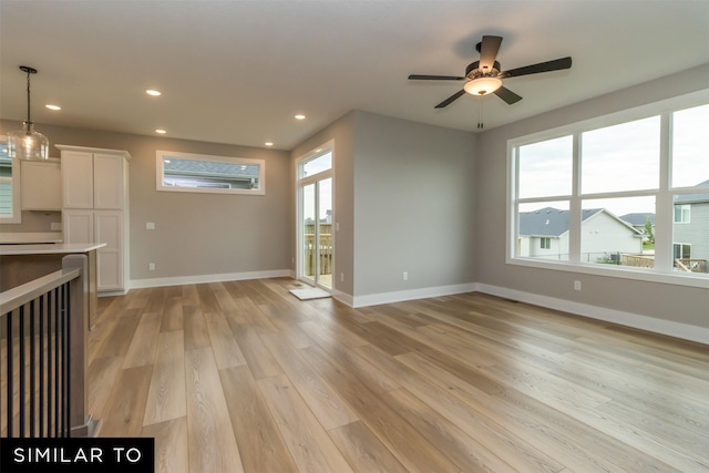 1435 Locust St, Waukee, IA 50263 - unfurnished living room with light wood-type flooring, recessed lighting, and ceiling fan