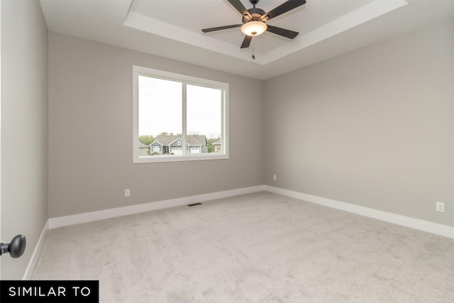 1435 Locust St, Waukee, IA 50263 - carpeted spare room with a tray ceiling and a ceiling fan