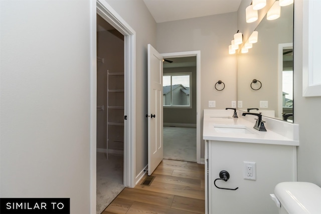 1435 Locust St, Waukee, IA 50263 - bathroom with wood finished floors, double vanity, and a chandelier