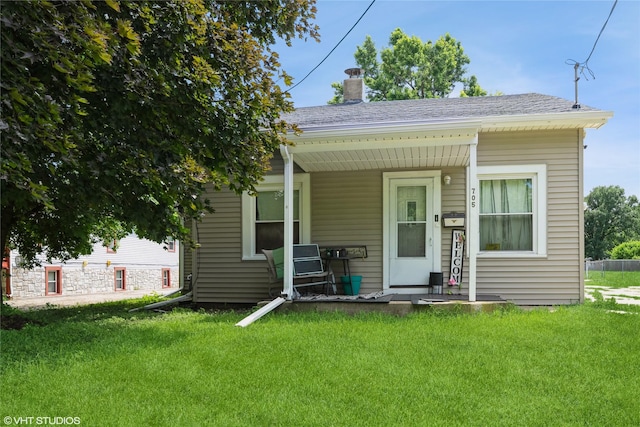 705 E Miller Ave, Des Moines, IA 50315 - bungalow-style home featuring a chimney, a front yard, and covered porch