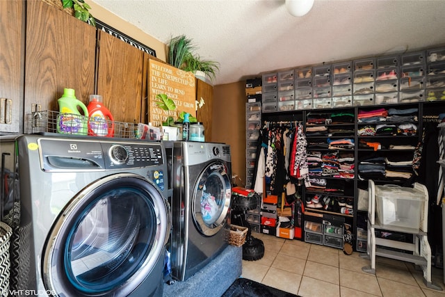 705 E Miller Ave, Des Moines, IA 50315 - laundry room with tile patterned floors, washer and clothes dryer, and a textured ceiling