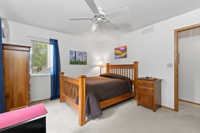 2207 Buchanan Dr, Ames, IA 50010 - bedroom with light carpet, a ceiling fan, and a textured ceiling