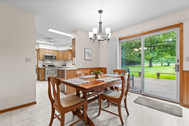 2207 Buchanan Dr, Ames, IA 50010 - dining room with a chandelier, wainscoting, and a textured ceiling