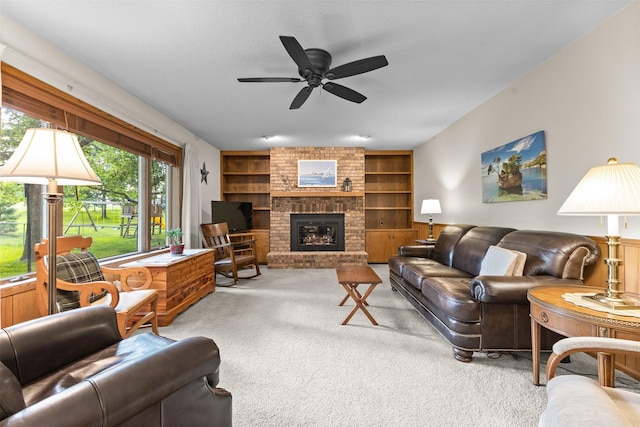 2207 Buchanan Dr, Ames, IA 50010 - carpeted living room featuring built in shelves, a brick fireplace, and ceiling fan