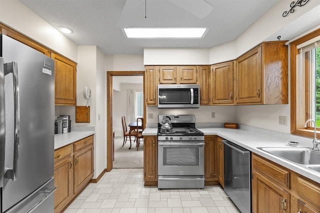 2207 Buchanan Dr, Ames, IA 50010 - kitchen featuring appliances with stainless steel finishes, brown cabinets, and light countertops