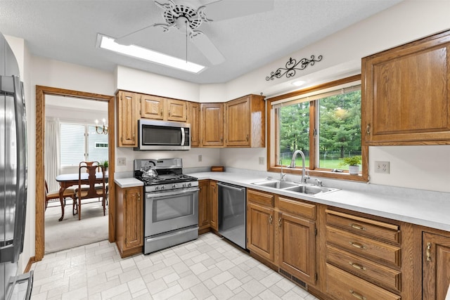 2207 Buchanan Dr, Ames, IA 50010 - kitchen featuring appliances with stainless steel finishes, ceiling fan, brown cabinets, and light countertops