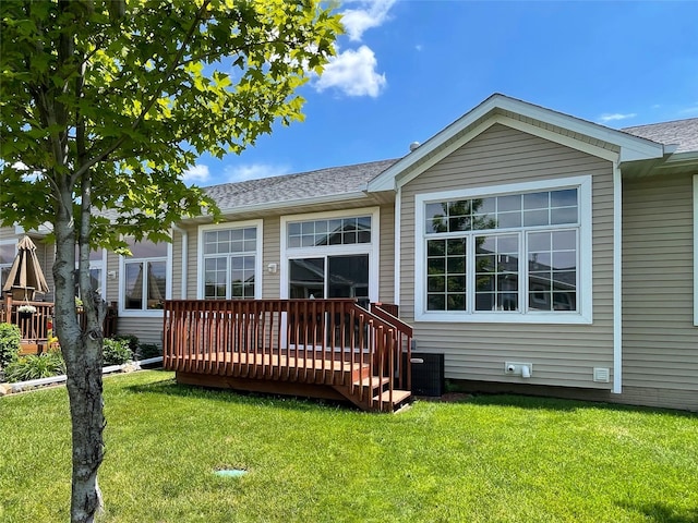 1406 SE Williams Ct, Waukee, IA 50263 - rear view of property with a deck, a lawn, and a shingled roof