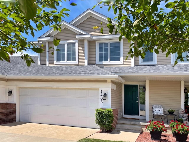 1406 SE Williams Ct, Waukee, IA 50263 - view of front of house featuring covered porch, concrete driveway, a shingled roof, and a garage