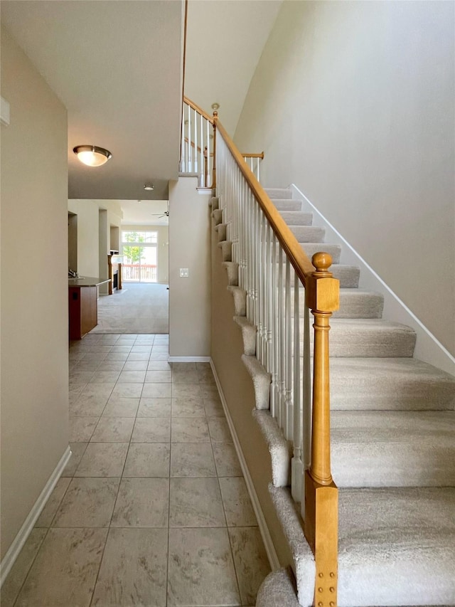 1406 SE Williams Ct, Waukee, IA 50263 - staircase featuring ceiling fan and tile patterned floors