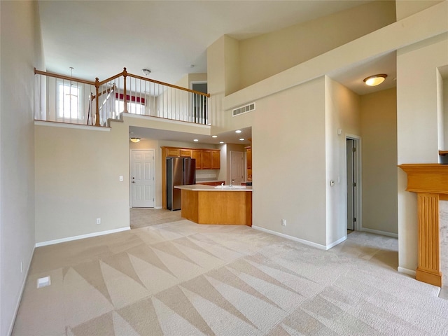 1406 SE Williams Ct, Waukee, IA 50263 - unfurnished living room featuring light colored carpet and a high ceiling