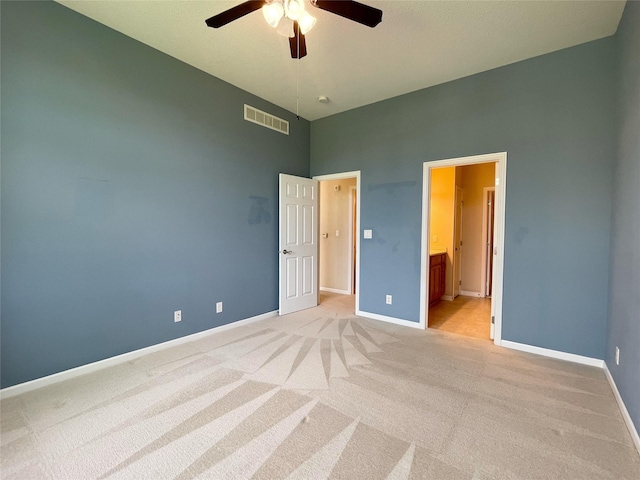 1406 SE Williams Ct, Waukee, IA 50263 - unfurnished bedroom with light colored carpet, a high ceiling, ensuite bathroom, and a ceiling fan