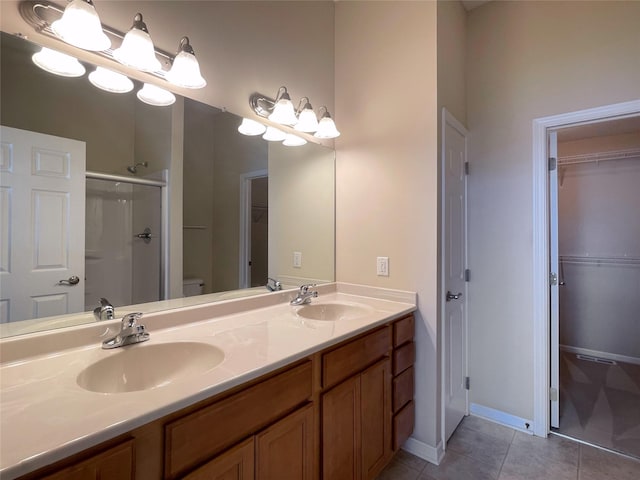 1406 SE Williams Ct, Waukee, IA 50263 - bathroom featuring a shower stall, a spacious closet, double vanity, and tile patterned floors