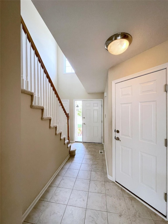 1406 SE Williams Ct, Waukee, IA 50263 - foyer with stairway and light tile patterned flooring