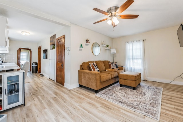 705 Prairie St, Adel, IA 50003 - living area with a ceiling fan, plenty of natural light, light wood-type flooring, and arched walkways