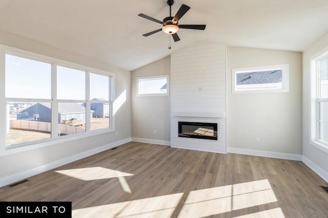 1425 Locust St, Waukee, IA 50263 - unfurnished living room with a fireplace, wood finished floors, a ceiling fan, and lofted ceiling