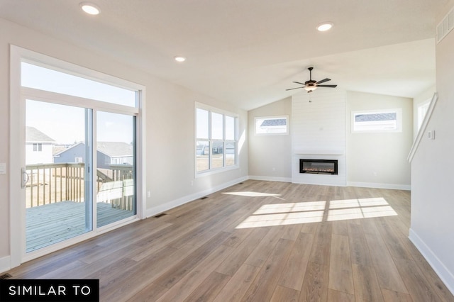 1425 Locust St, Waukee, IA 50263 - unfurnished living room with a ceiling fan, light wood-type flooring, a large fireplace, plenty of natural light, and vaulted ceiling