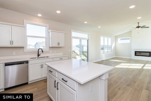 1425 Locust St, Waukee, IA 50263 - kitchen with stainless steel dishwasher, open floor plan, a ceiling fan, light wood finished floors, and lofted ceiling