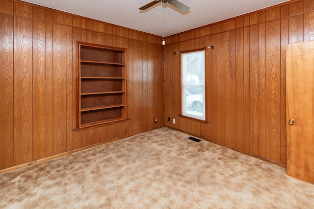 931 Pleasant View Dr, Des Moines, IA 50315 - carpeted spare room featuring wooden walls, a ceiling fan, and a textured ceiling