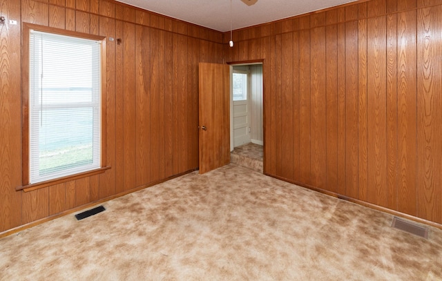 931 Pleasant View Dr, Des Moines, IA 50315 - carpeted empty room featuring wooden walls and ceiling fan