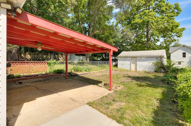 931 Pleasant View Dr, Des Moines, IA 50315 - fenced backyard with a patio area, a detached garage, and a storage shed