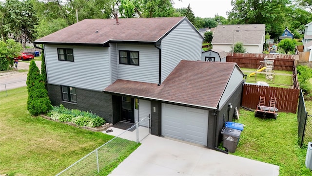205 E Livingston Ave, Des Moines, IA 50315 - view of front of house featuring a shingled roof, a garage, driveway, and a storage shed