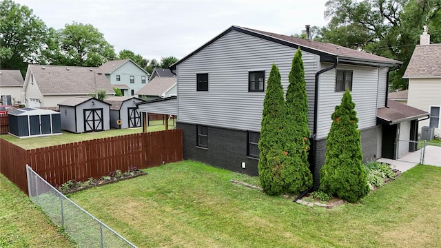 205 E Livingston Ave, Des Moines, IA 50315 - back of house featuring a shed, a fenced backyard, and a residential view