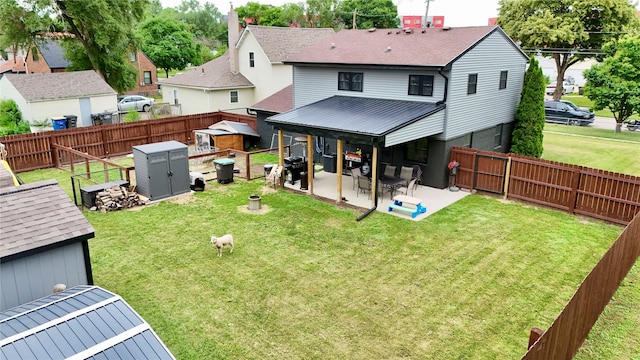 205 E Livingston Ave, Des Moines, IA 50315 - back of house featuring a storage shed, a fenced backyard, a patio, and roof with shingles
