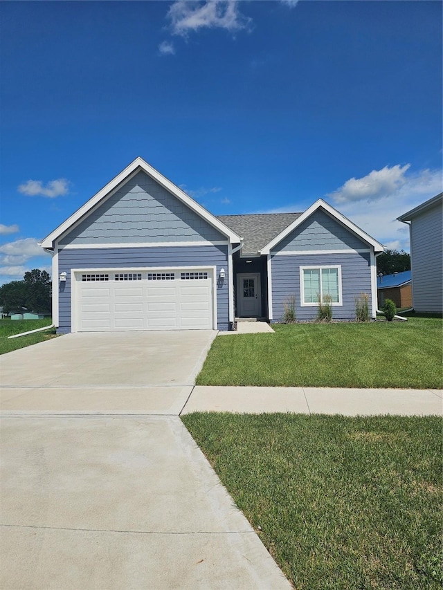 1108 28th St, Perry, IA 50220 - single story home featuring concrete driveway, a front yard, and a garage