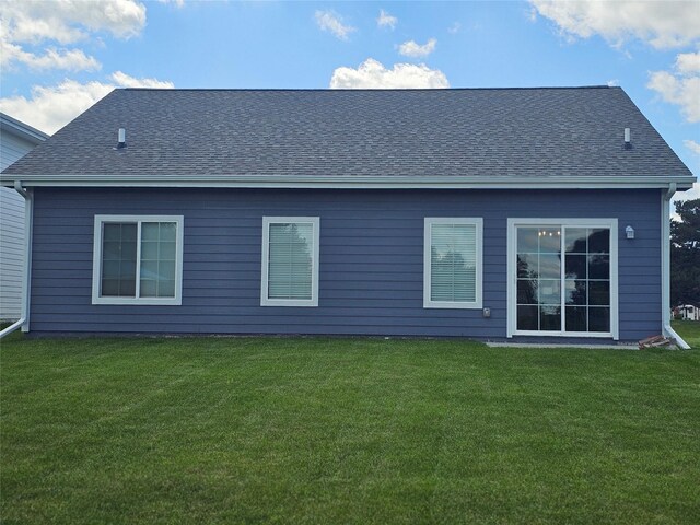 1108 28th St, Perry, IA 50220 - back of house with a lawn and a shingled roof