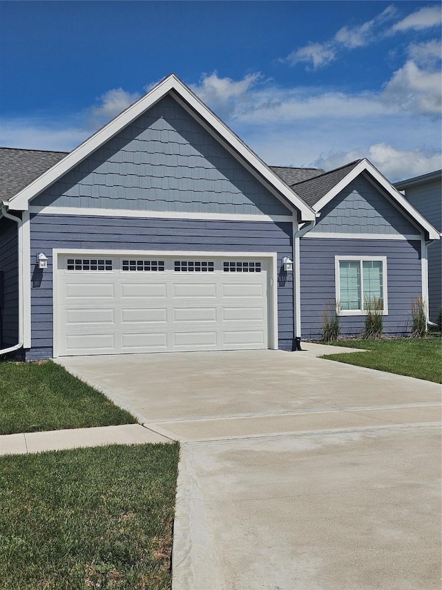 1108 28th St, Perry, IA 50220 - view of front facade featuring driveway and a garage