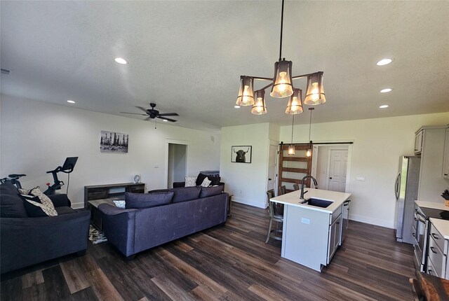 1108 28th St, Perry, IA 50220 - living area with dark wood-type flooring, a barn door, recessed lighting, and ceiling fan