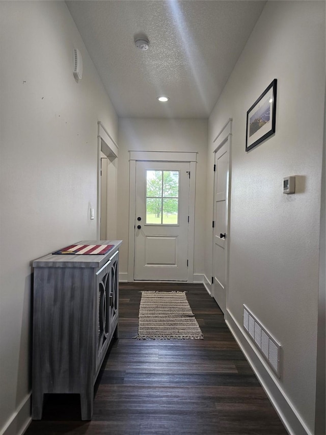 1108 28th St, Perry, IA 50220 - entryway featuring a textured ceiling, dark wood-type flooring, and recessed lighting