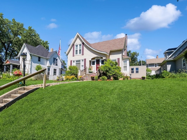 310 Greene St, Boone, IA 50036 - back of house with a yard, a residential view, and a chimney