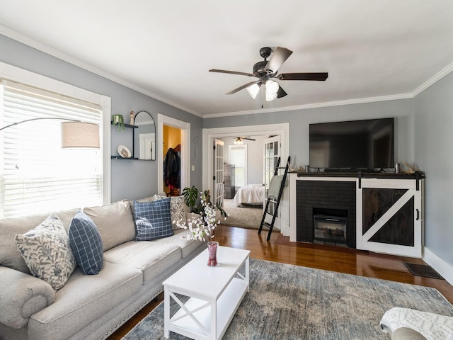 310 Greene St, Boone, IA 50036 - living area with a ceiling fan, ornamental molding, wood finished floors, and a brick fireplace