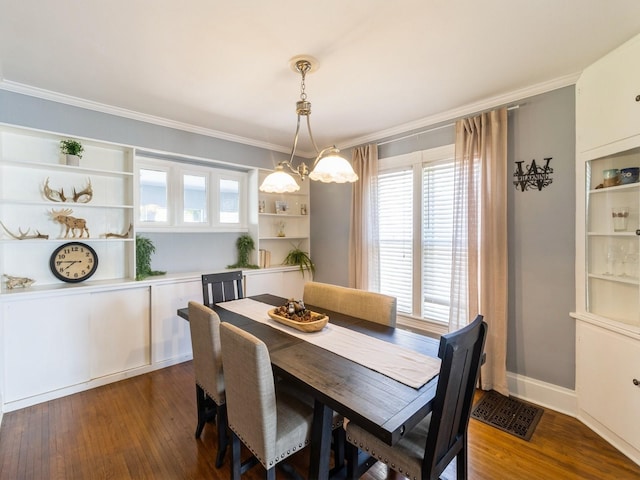 310 Greene St, Boone, IA 50036 - dining area featuring crown molding and dark wood finished floors