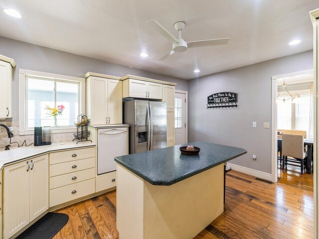 310 Greene St, Boone, IA 50036 - kitchen featuring stainless steel refrigerator with ice dispenser, white dishwasher, a ceiling fan, light wood finished floors, and plenty of natural light