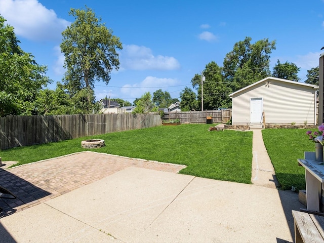 310 Greene St, Boone, IA 50036 - fenced backyard featuring a patio area, a fire pit, and an outdoor structure