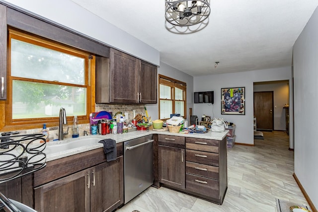2908 Woodland Ave, West Des Moines, IA 50266 - kitchen featuring dishwasher, light countertops, dark brown cabinetry, decorative backsplash, and a peninsula