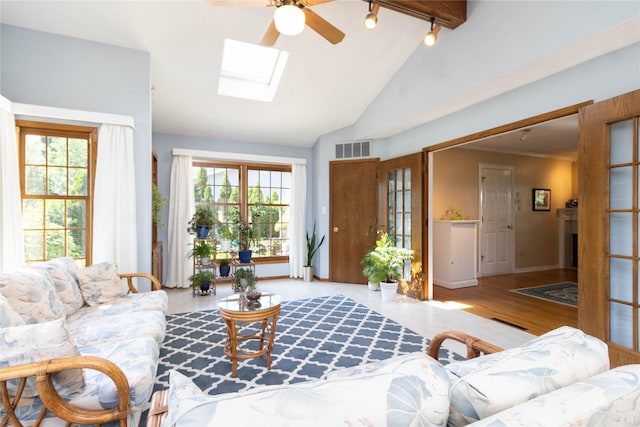 1809 79th St, Windsor Heights, IA 50324 - living area with vaulted ceiling, a skylight, ceiling fan, track lighting, and wood finished floors
